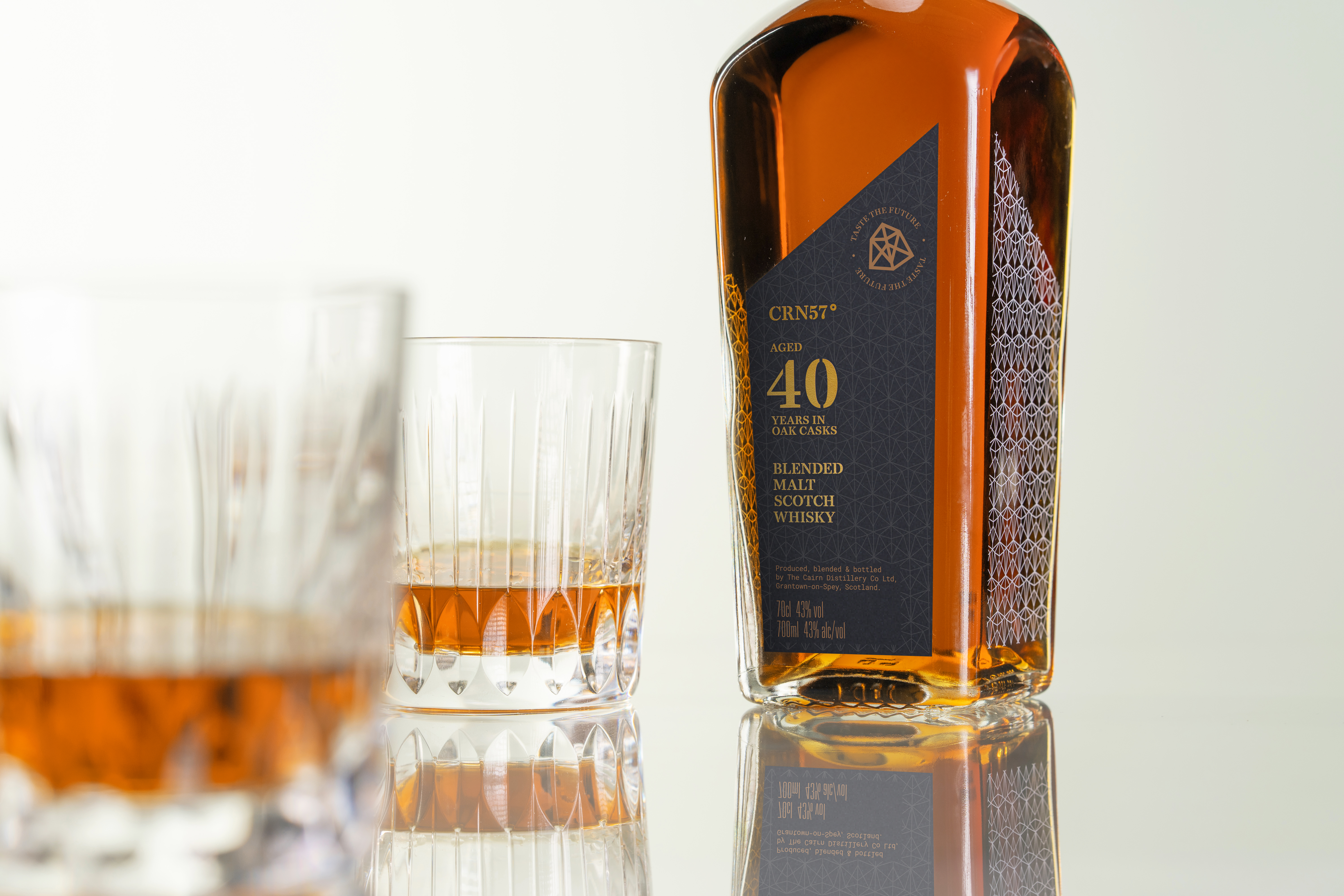 A bottle of CRN57 40 years old whisky with two glasses