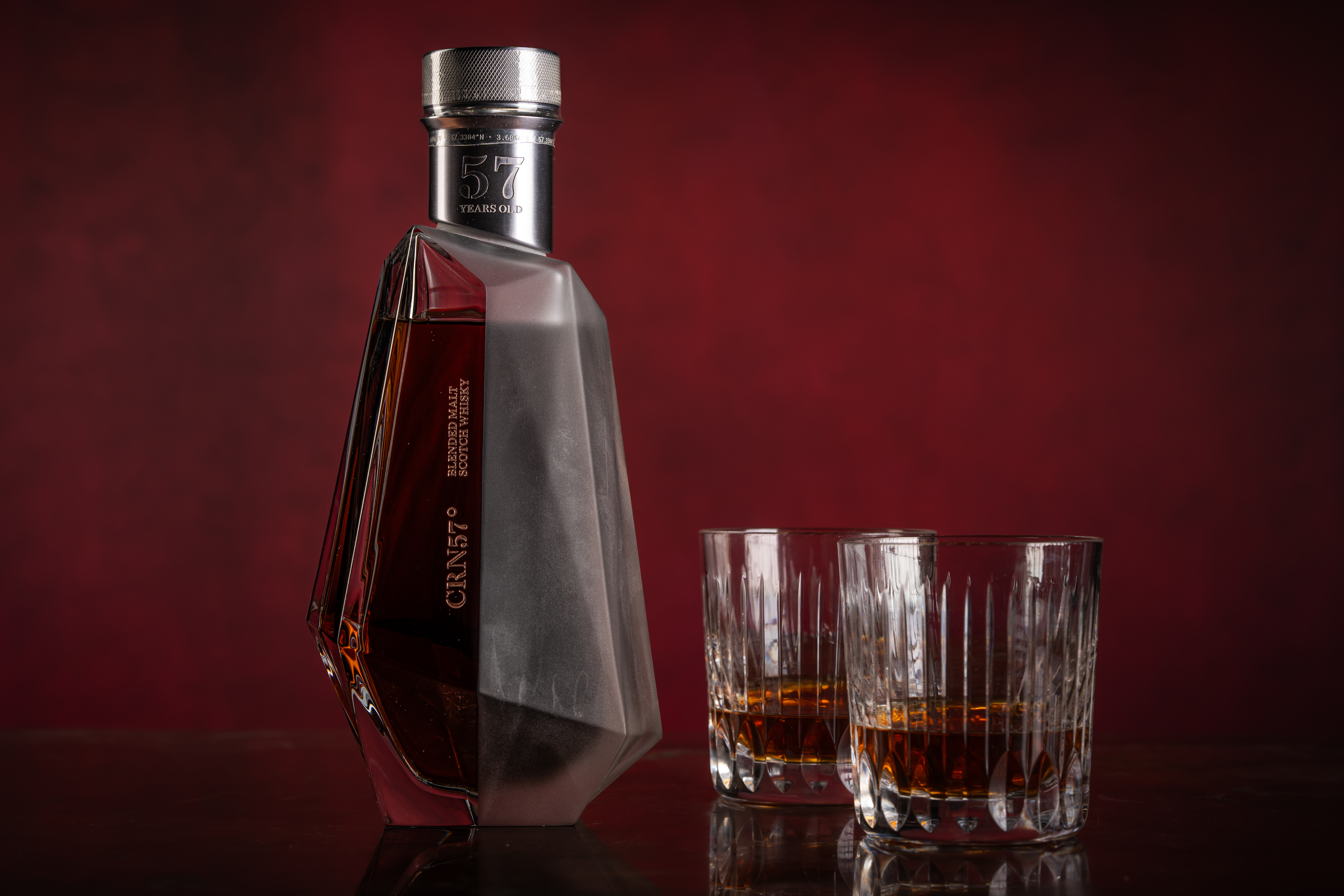 A whisky decanter containing CRN57 57 year old blended malt Scotch whisky and two glasses