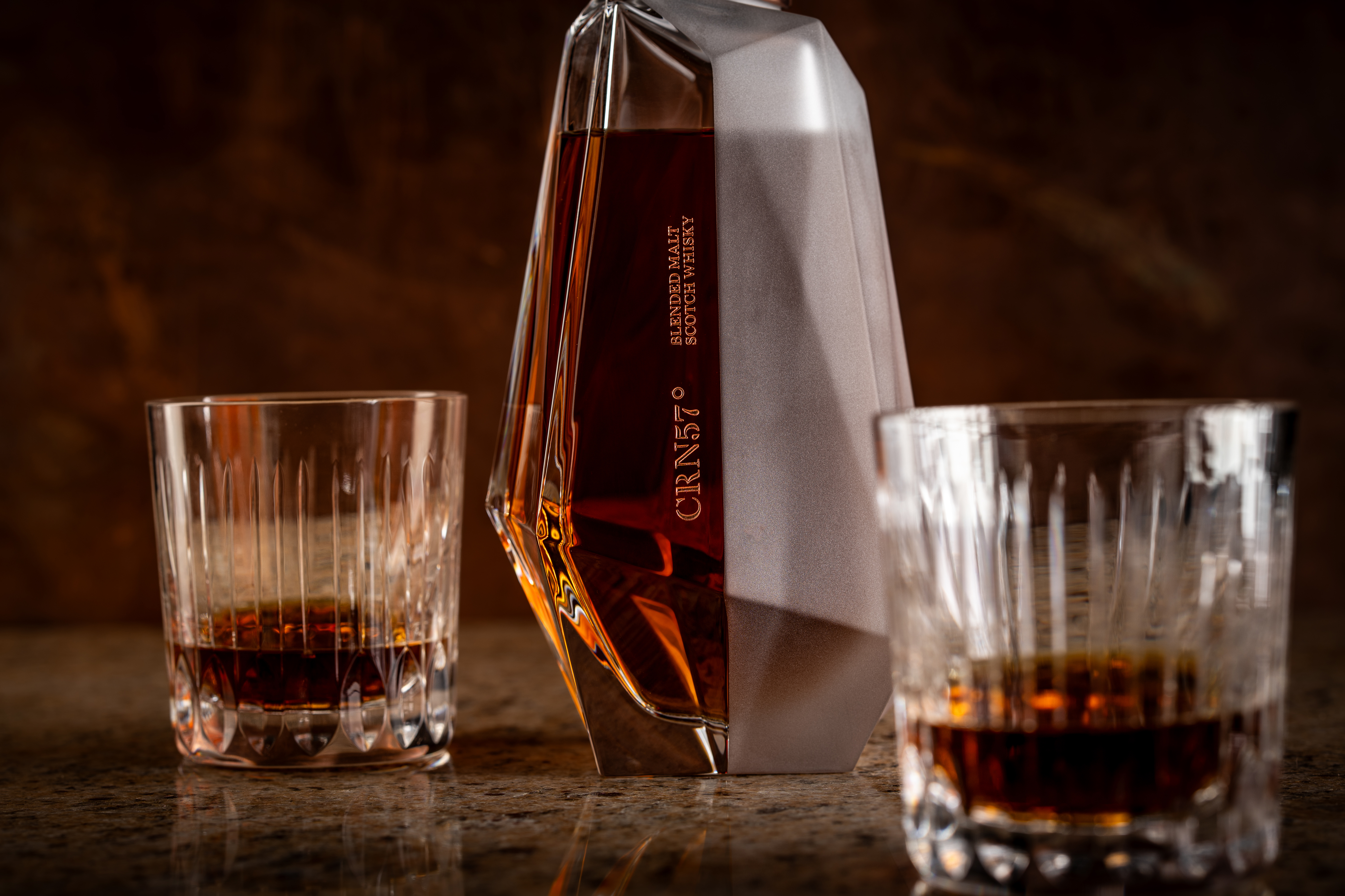 A whisky decanter containing CRN57 70 year old blended malt Scotch whisky and two glasses